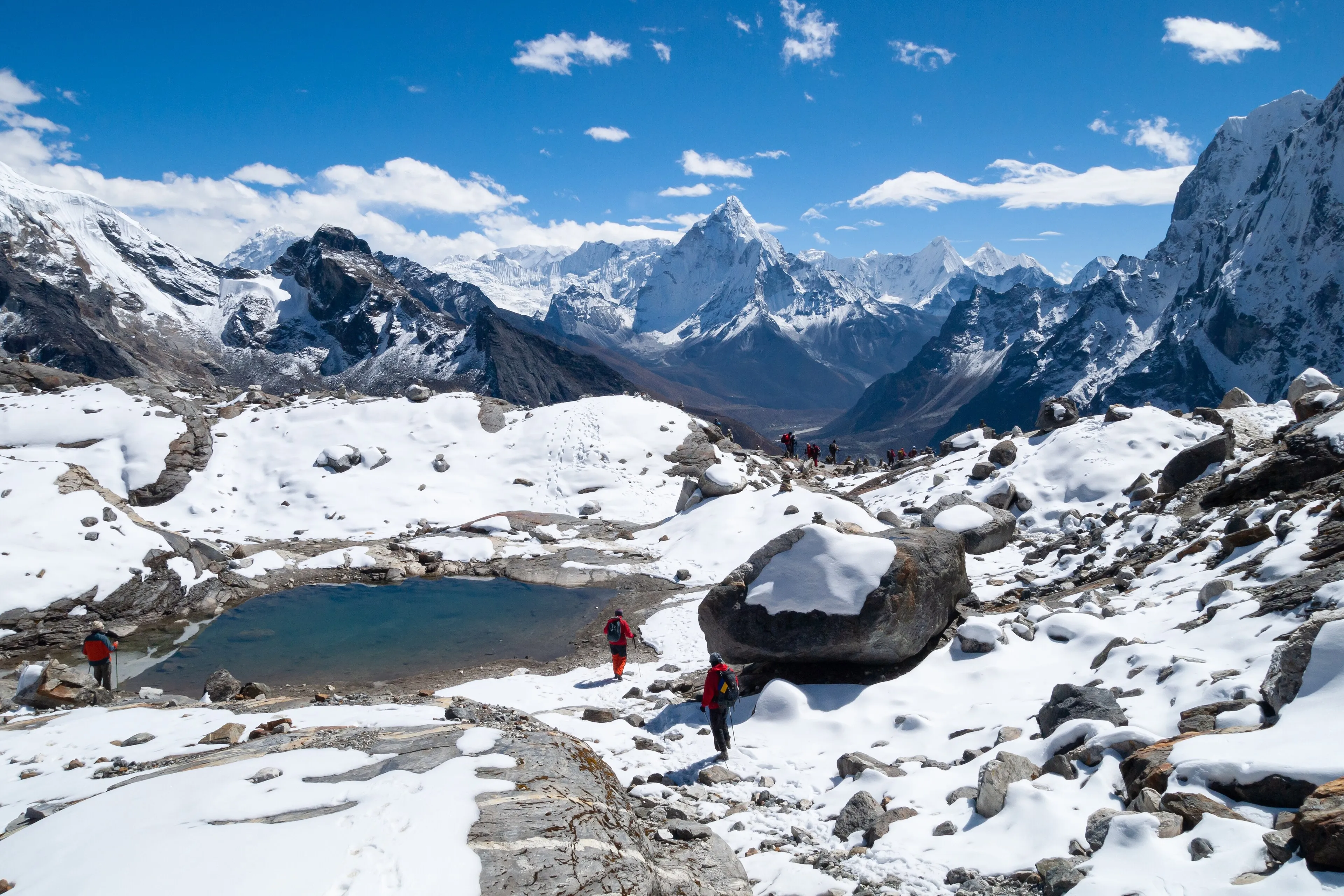 Seasonal Himalayan landscape with snow-dusted ridges and open meadow
